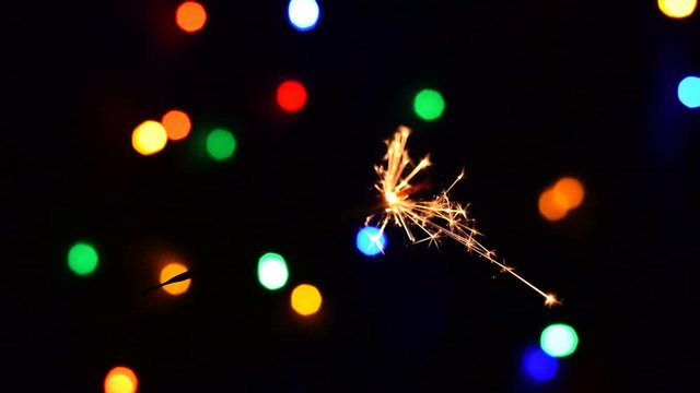 Video HD with burning sparkler or bengal light in the silvester holiday night
