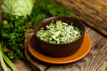 fresh cabbage salad in a clay plate