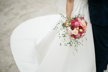 pink peonies wedding bouquet and white dress