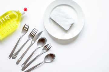 concept of washing dishes on white background top view