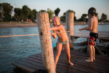 girl play with small boat on seaside