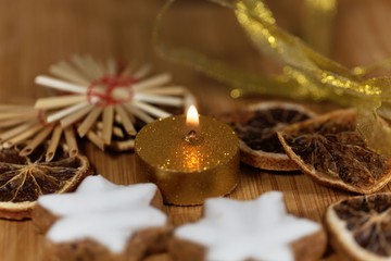 Golden candle with Christmas cookies and decoration