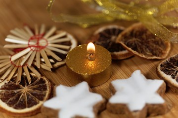 Fototapeta na wymiar Golden candle with Christmas cookies and decoration