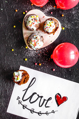 concept of Valentine's Day cupcakes dark background top view