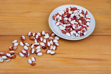 Obraz na płótnie Canvas beans on a saucer and scattered on the table