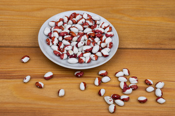 Fototapeta na wymiar beans on a saucer and scattered on the table