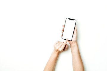 Woman touching blank screen of new model of smart phone on white background. Flat lay, top view mockup.