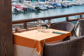 Empty table in the outdoor restaurant at the harbor