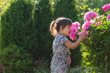 Portrait of a three year old girl playing in the garden.