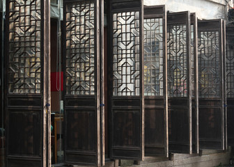 Decorative and traditional ancient entrance doors of a shop and restaurant in the old town of Suzhou city, China, Asia