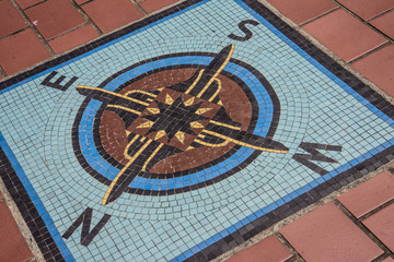 Navigation compass mosaic on the ground