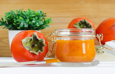 Homemade persimmon (kaki) face mask in a glass jar. DIY cosmetics and spa. Copy space.  
