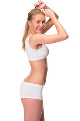 Fototapeta premium Young beautiful blonde woman in white fitness clothing