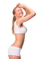 Fototapeta premium Young beautiful blonde woman in white fitness clothing