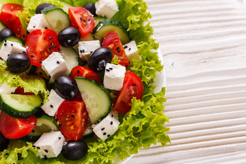 Greek salad on a wooden rustic background