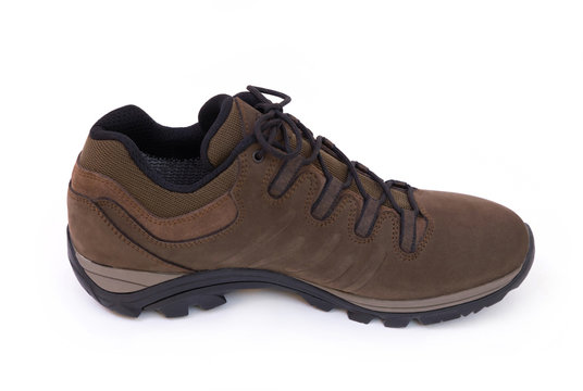 Closeup of a single brown unbranded trekking shoe isolated on white background