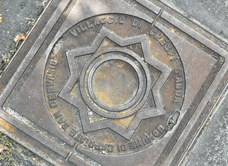 Manhole cover with the Crespi family logo