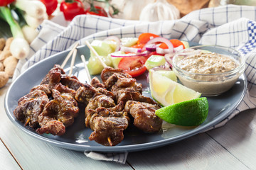 Traditional pork satay with peanut sauce and vegetables