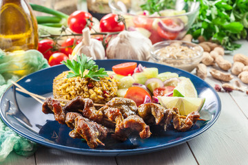 Traditional pork satay with peanut sauce and vegetables