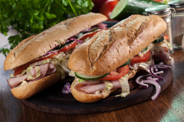 Submarine sandwiches with ham, cheese and vegetables