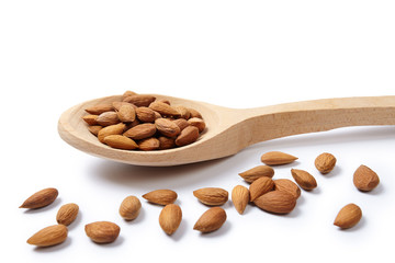 Pelled almonds in woodeen spoon. Cut out.