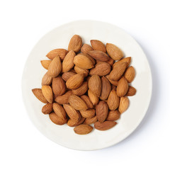 Raw peeled almonds on white plate. Top view. Cut  out.