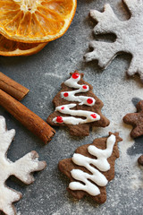 Postcard Christmas cookies in the form of flakes, decorated with dried orange, cinnamon sticks and anise, the background is sprinkled with flour. Copy space.Tinted effect.