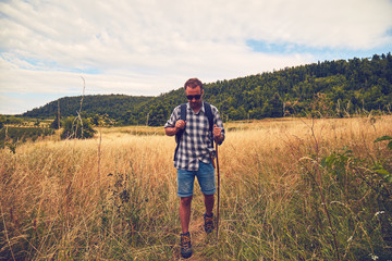 Hiker enjoying nice view in a hilly landscape.