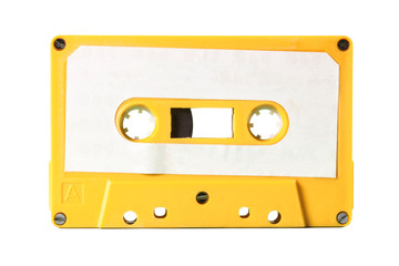 Obraz premium An old vintage cassette tape from the 1980s (obsolete music technology). Electro yellow plastic body, white paper label, isolated. 
