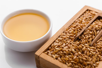 Seeds of golden flax on a white background