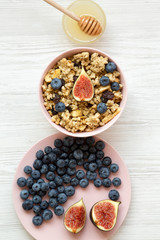 Granola with fruits and honey, overhead view. Flat lay, from above, top view. Close-up.
