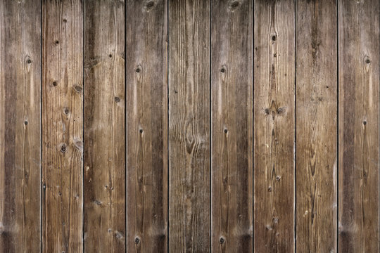 Brown wood texture. Abstract background, empty template. rustic weathered barn wood background with knots and nail holes. Close up of wall made of wooden planks.