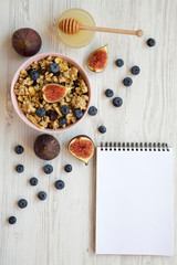 Fruit granola and blank notepad, top view. Flat lay, from above, overhead. Copy space.