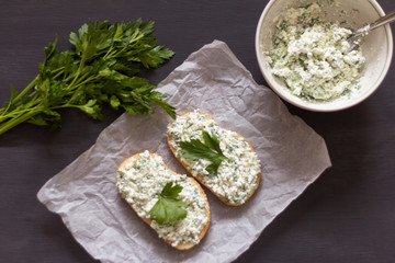 sandwiches with cottage cheese and herbs on a dark background
