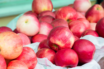 Red ripe apples on the counter of the street market.