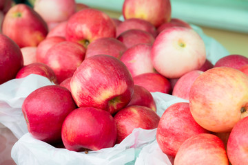 Red ripe apples on the counter of the street market.