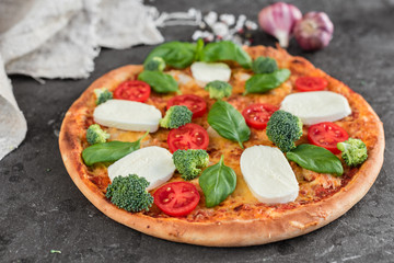 Pizza, food, vegetable, margarita.  Vegetables, mushrooms and tomatoes pizza on a black wooden background. It can be used as a background