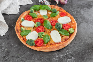 Pizza, food, vegetable, margarita.  Vegetables, mushrooms and tomatoes pizza on a black wooden background. It can be used as a background