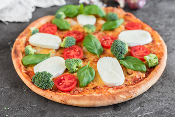 Pizza, food, vegetable, margarita.  Vegetables, mushrooms and tomatoes pizza on a black wooden background. It can be used as a background