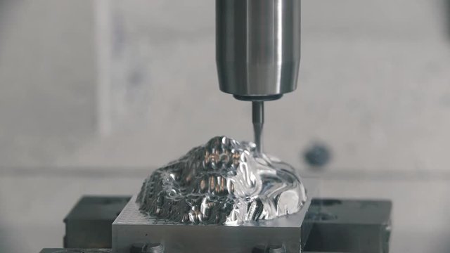CNC maching doing an metal carving. Slow motion