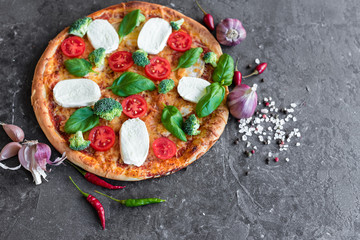 Pizza, food, vegetable, margarita.  Vegetables, mushrooms and tomatoes pizza on a black wooden background. It can be used as a background