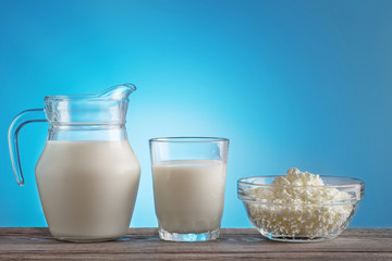 Cottage cheese and milk on wooden table