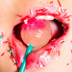 Sweet lollipop in the mouth of a young girl. Erotic concept. Seductive sensual mouth. A young woman...