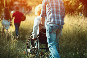 Man pushes woman in wheelchair to run after kids