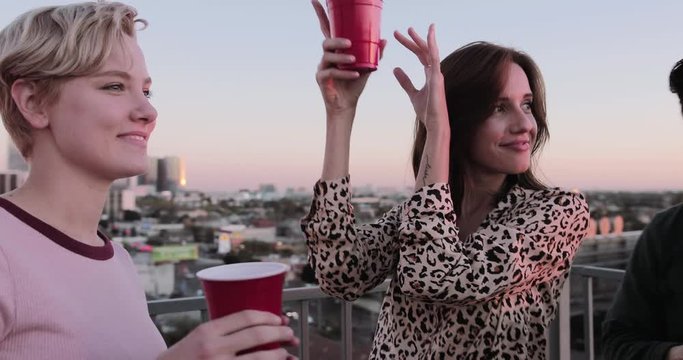 Group of friends dancing at a rooftop party