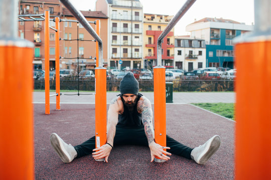 Man using parallel bars in outdoor gym