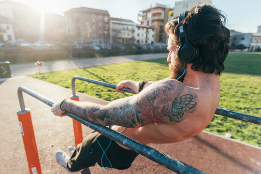Man using parallel bars in outdoor gym