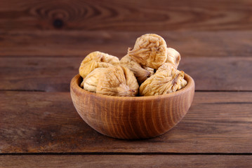 Dry figs on a wooden background.