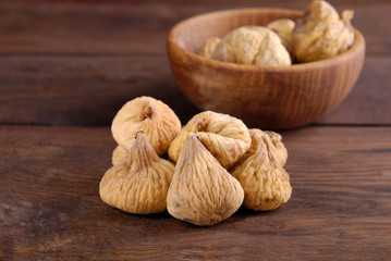 Dry figs on a wooden background.