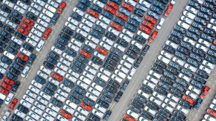 Cars export terminal in export and import business and logistics. Shipping cargo to harbor. Water transport International. Aerial view and top view.